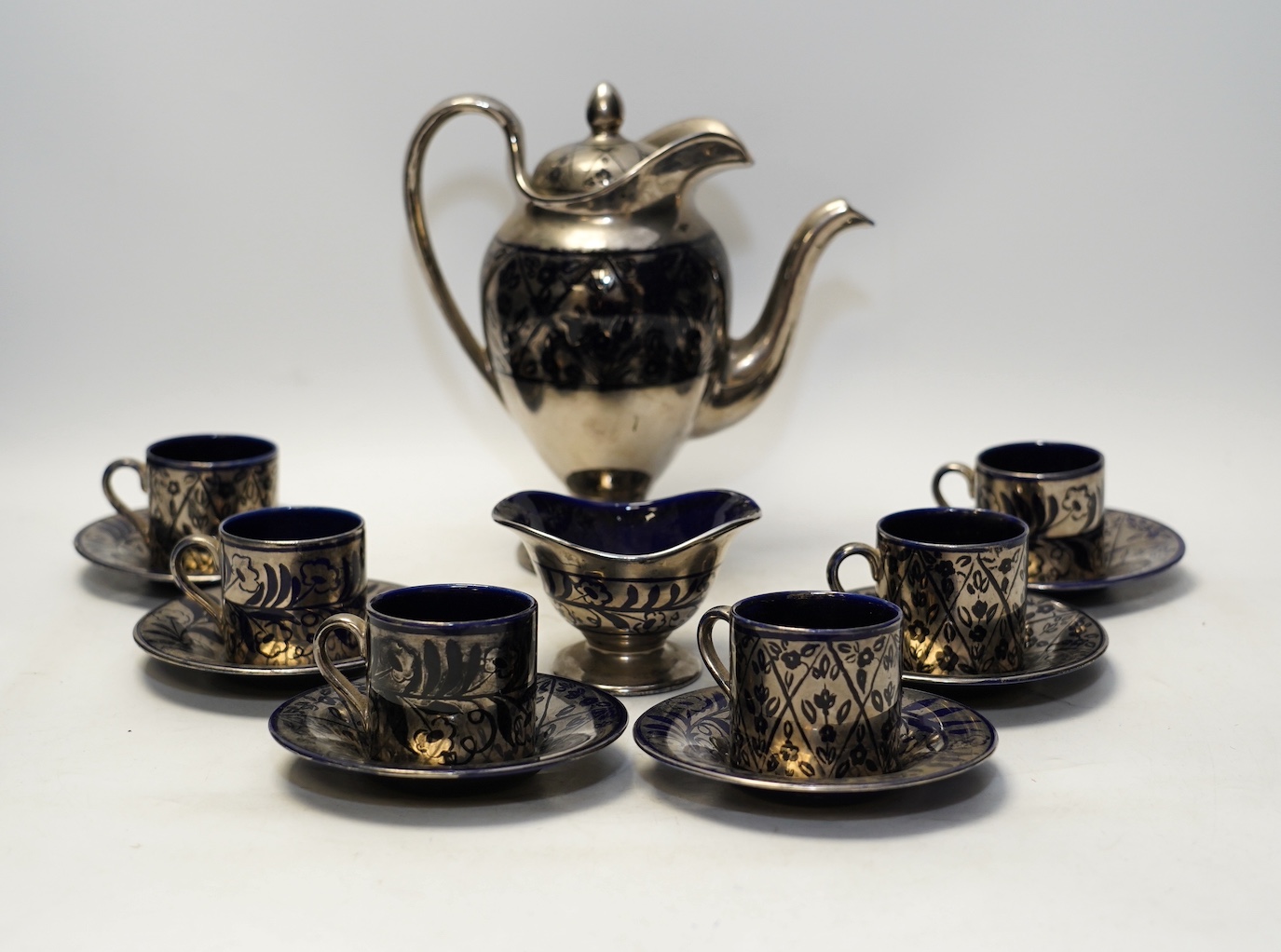 Charlotte Rhead, a Bursley ware thirteen piece coffee set, silver resist. 20cm. Condition - fair